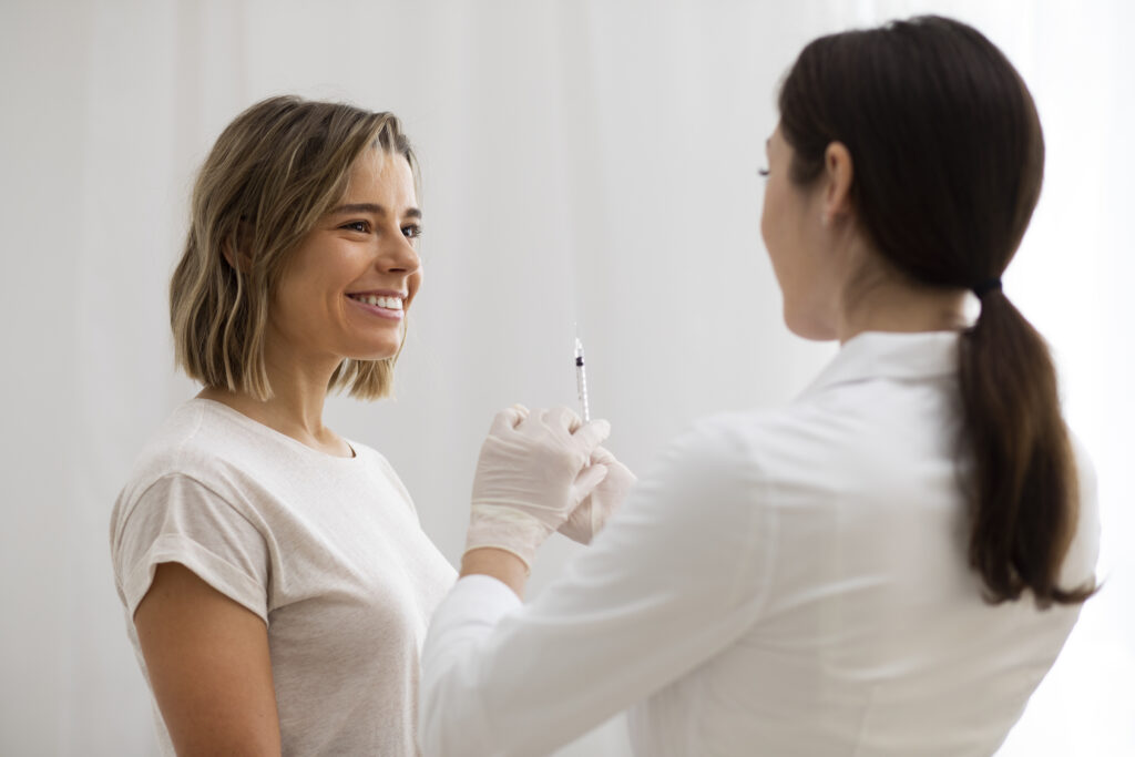 medium shot doctor holding syringe